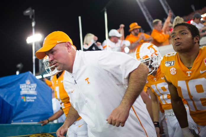 Tennessee football coach Jeremy Pruitt runs onto the field during the Gator Bowl game between Tennessee and Indiana at the TIAA Bank Field in Jacksonville, Fla., Jan. 2, 2020.