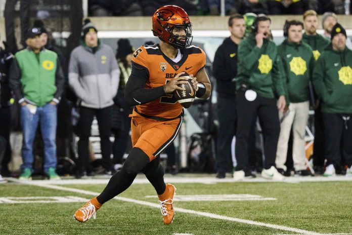 Oregon State Beavers quarterback DJ Uiagalelei (5) rolls out to pass the ball during the first half against the Oregon Ducks at Autzen Stadium.
