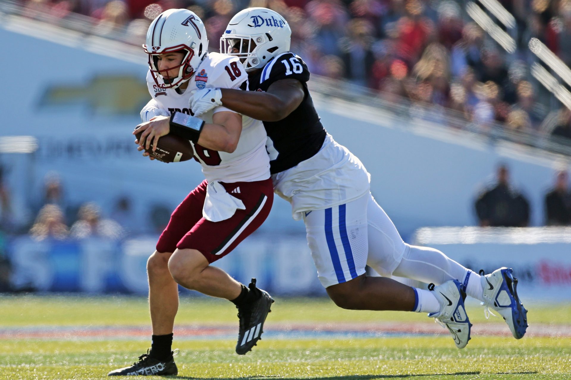 Dec 23, 2023; Birmingham, AL, USA; Duke Blue Devils defensive linemen Aeneas Peebles (16) sacks Troy Trojans quarterback Gunnar Watson (18) during the first half at Protective Stadium. Mandatory Credit: Petre Thomas-USA TODAY Sports