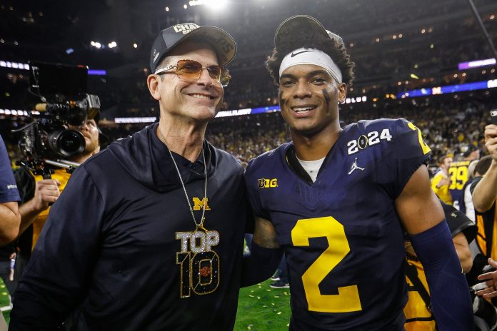 Michigan head coach Jim Harbaugh and defensive back Will Johnson (2) celebrate after their 34-13 win over Washington to win the national championship at NRG Stadium in Houston on Monday, Jan. 8, 2024.