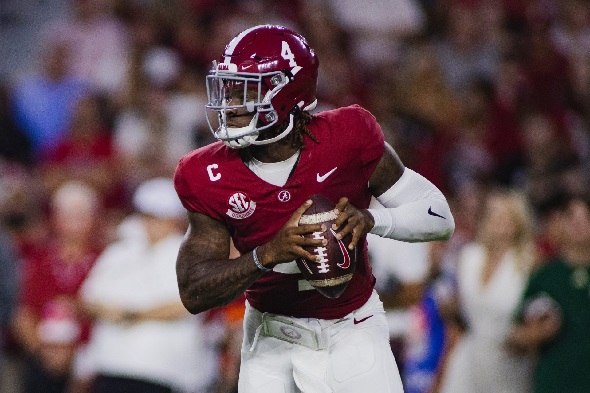 Sep 7, 2024; Tuscaloosa, Alabama, USA; Alabama Crimson Tide quarterback Jalen Milroe (4) looks for a pass against the South Florida Bulls during the second quarter at Bryant-Denny Stadium. Mandatory Credit: William McLelland-Imagn Images