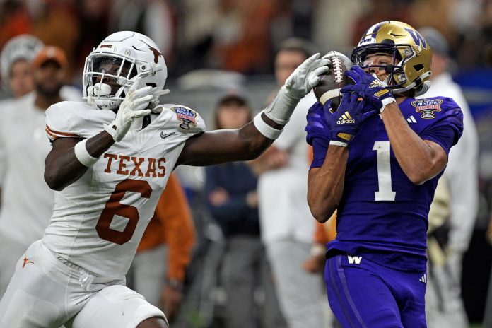 Washington Huskies wide receiver Rome Odunze (1) catches a pass against Texas Longhorns defensive back Ryan Watts (6) during the fourth quarter in the 2024 Sugar Bowl college football playoff semifinal game at Caesars Superdome.