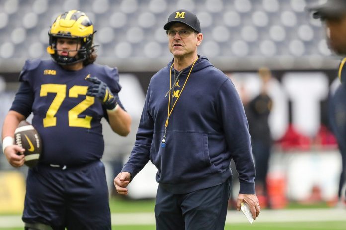Michigan head coach Jim Harbaugh watches warmups during open practice at NRG Stadium in Houston, Texas on Saturday, Jan. 6, 2024, two days before the national championship game vs. Washington.
