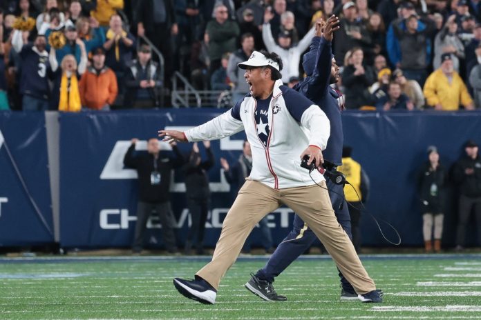 Navy Midshipmen head coach Ken Niumatalolo celebrates after Army turns the ball over on downs during the fourth quarter at MetLife Stadium.