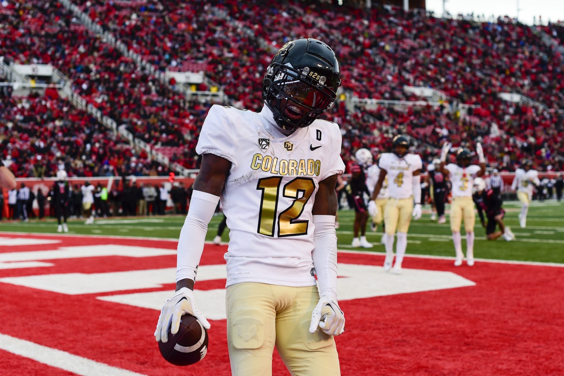 Colorado Buffaloes athlete Travis Hunter (12) reacts after scoring a touchdown against the Utah Utes at Rice-Eccles Stadium.