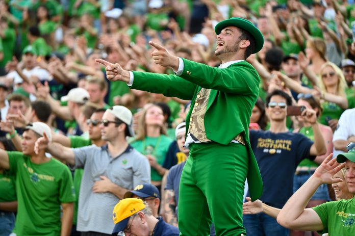 Sep 2, 2023; South Bend, Indiana, USA; The Notre Dame Fighting Irish leprechaun mascot leads the student section in cheering in the fourth quarter against the Tennessee State Tigers at Notre Dame Stadium. Mandatory Credit: Matt Cashore-USA TODAY Sports