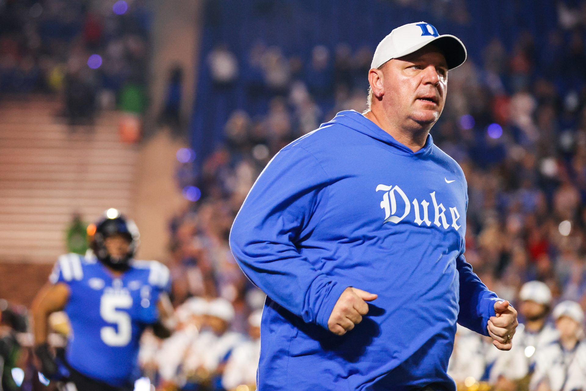 Oct 14, 2023; Durham, North Carolina, USA; Duke Blue Devils head coach Mike Elko runs out before the first half of the game against North Carolina State Wolfpack at Wallace Wade Stadium. Mandatory Credit: Jaylynn Nash-USA TODAY Sports