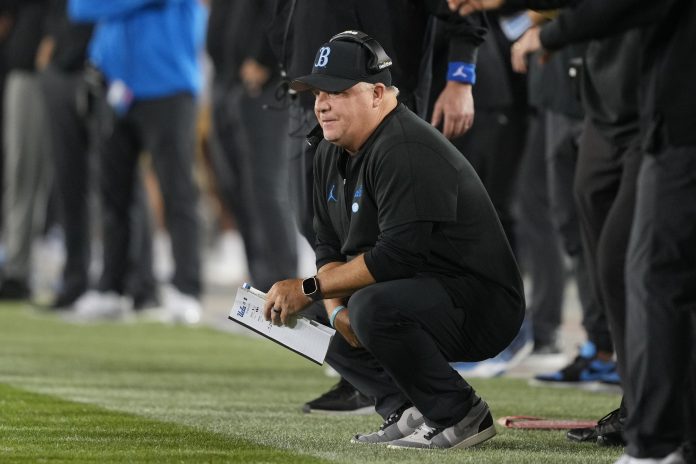 Oct 21, 2023; Stanford, California, USA; UCLA Bruins head coach Chip Kelly kneels on the sideline during the third quarter against the Stanford Cardinal at Stanford Stadium. Mandatory Credit: Darren Yamashita-USA TODAY Sports