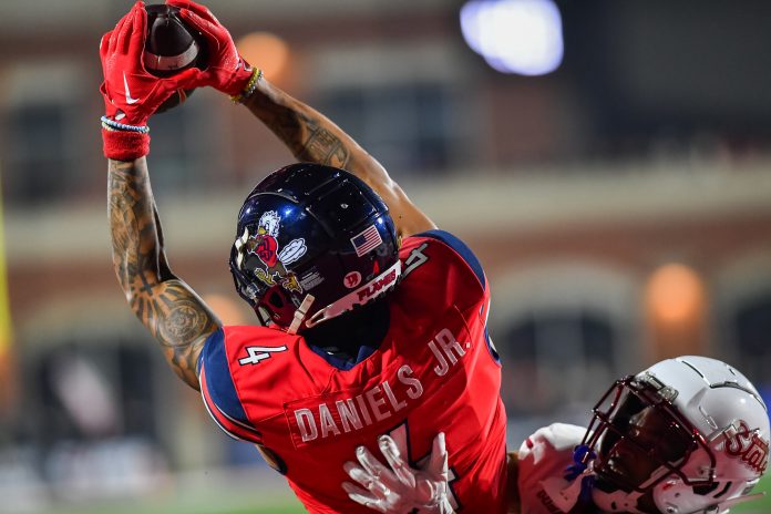 Dec 1, 2023; Lynchburg, VA, USA; Liberty Flames wide receiver CJ Daniels (4) catches a touchdown pass against the New Mexico State Aggies during the third quarter at Williams Stadium. Mandatory Credit: Brian Bishop-USA TODAY Sports