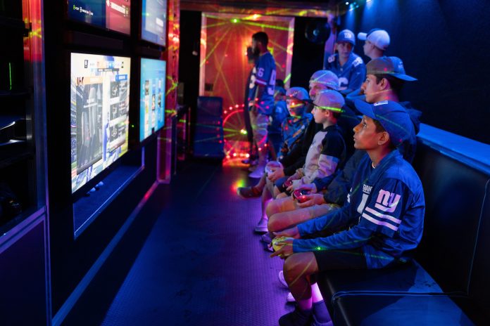 Kids play video games in a Game Rider NJ game truck during New York Giants Fan Fest at MetLife stadium in East Rutherford on Thursday, August 24, 2023.