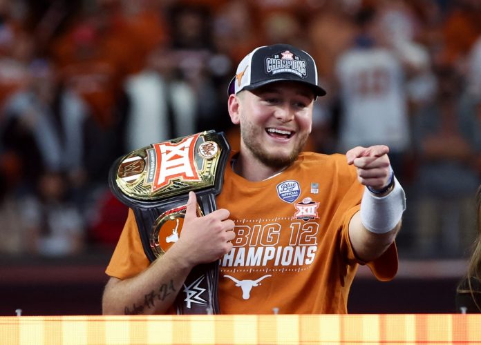 Texas Longhorns quarterback Quinn Ewers (3) reacts with the WWE Big 12 championship belt after the win against the Oklahoma State Cowboys at AT&T Stadium.