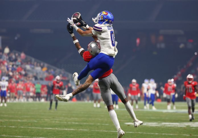 Kansas Jayhawks wide receiver Quentin Skinner (0) makes a catch against UNLV Rebels defensive back Ricky Johnson (33) during the second half in the Guaranteed Rate Bowl at Chase Field.