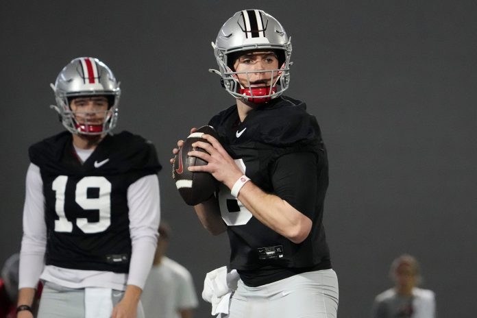 Ohio State Buckeyes quarterback Will Howard (18) looks to throw during spring football practice at the Woody Hayes Athletic Center.