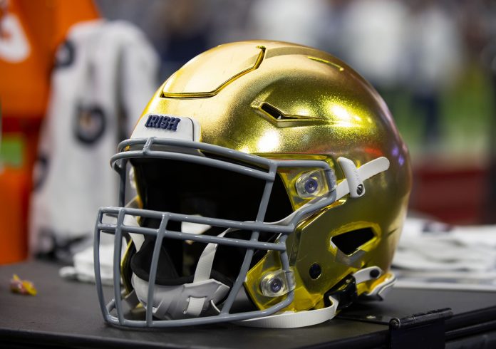 Detailed view of a gold Notre Dame Fighting Irish helmet during the 2022 Fiesta Bowl at State Farm Stadium.