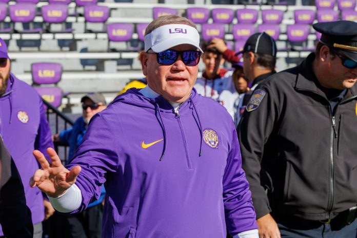 LSU Tigers head coach Brian Kelly waves to fans during warmups before the game against the Texas A&M Aggies at Tiger Stadium.
