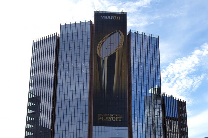The College Football Playoff logo on a building in downtown.