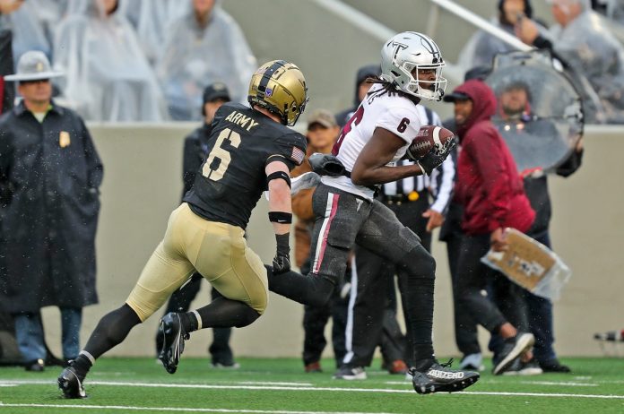 Troy Trojans wide receiver Chris Lewis (6) catches a pass for a touchdown in front of Army Black Knights defensive back Max DiDomenico (6) during the first half at Michie Stadium.