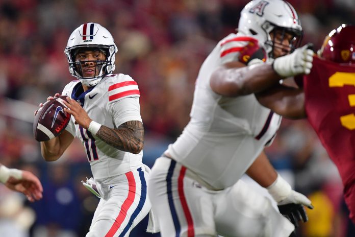 Oct 7, 2023; Los Angeles, California, USA; Arizona Wildcats quarterback Noah Fifita (11) drops back to pass against the Southern California Trojans during the first half at Los Angeles Memorial Coliseum. Mandatory Credit: Gary A. Vasquez-USA TODAY Sports
