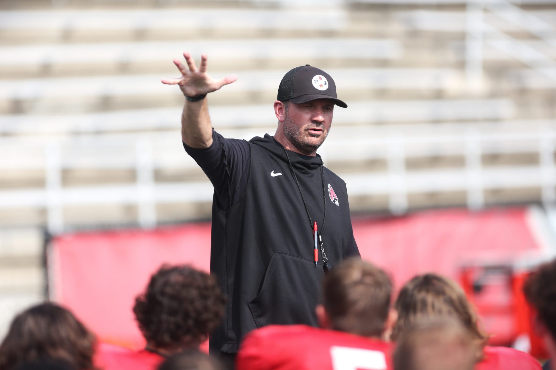 Ball State football head coach Mike Neu speaks to his team after a 2023 preseason practice at Scheumann Stadium.