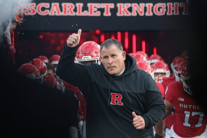 Nov 25, 2023; Piscataway, New Jersey, USA; Rutgers Scarlet Knights head coach Greg Schiano runs out to the field with his team before the game against the Maryland Terrapins at SHI Stadium. Mandatory Credit: Vincent Carchietta-USA TODAY Sports