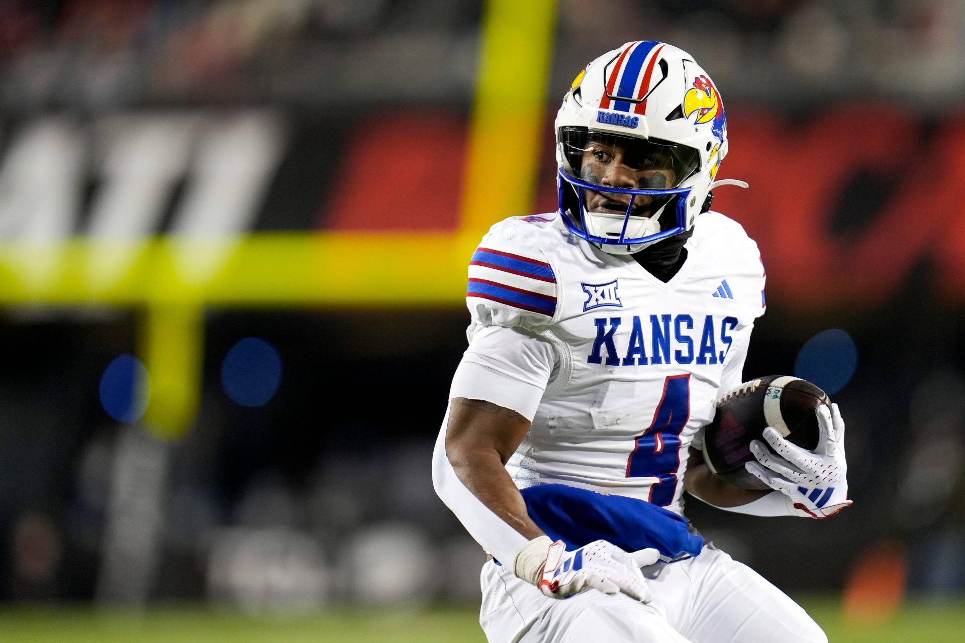 Kansas Jayhawks running back Devin Neal (4) scores a touch down during the NCAA college football game between the Cincinnati Bearcats and Kansas Jayhawks on Saturday, Nov. 25, 2023, at Nippert Stadium in Cincinnati. This is the Bearcats’ last game of the season, as well as their Senior Night Saturday.