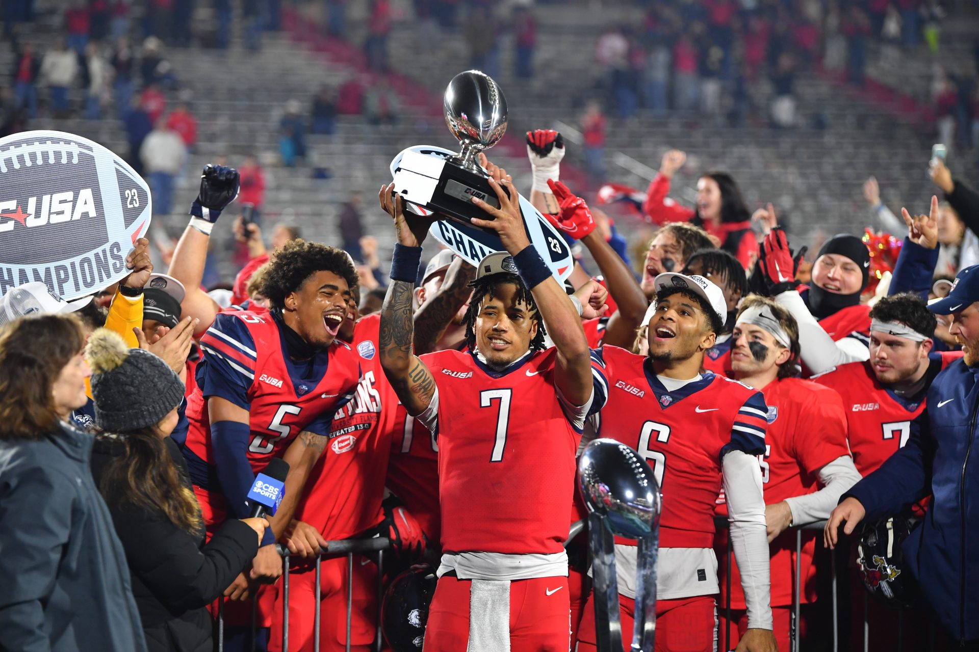 Dec 1, 2023; Lynchburg, VA, USA; Liberty Flames quarterback Kaidon Salter (7) holds up the Conference USA MVP trophy after the game against the New Mexico State Aggies at Williams Stadium. Mandatory Credit: Brian Bishop-USA TODAY Sports