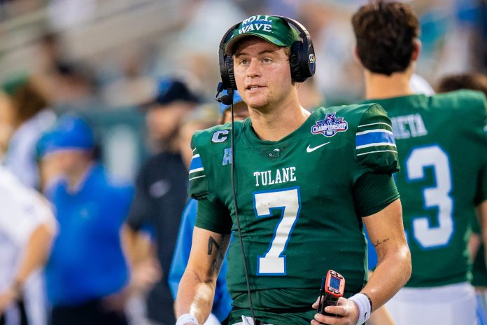 Dec 2, 2023; New Orleans, LA, USA; Tulane Green Wave quarterback Michael Pratt (7) talks to the coaching staff on the headset when Southern Methodist Mustangs is on the field during the first half at Yulman Stadium. Mandatory Credit: Stephen Lew-USA TODAY Sports
