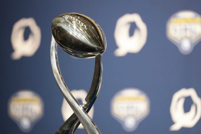 Dec 28, 2023; Arlington, Texas, USA; The Field Scovell Trophy sits on the desk before Ohio State Buckeyes head coach Ryan Day and Missouri Tigers head coach Eliah Drinkwitz give a press conference prior to the Goodyear Cotton Bowl Classic at AT&T Stadium.