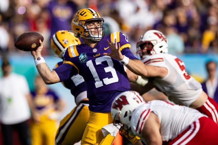 Jan 1, 2024; Tampa, FL, USA; LSU Tigers quarterback Garrett Nussmeier (13) throws the ball under pressure during the second half against the Wisconsin Badgers at the Reliaquest Bowl at Raymond James Stadium. Mandatory Credit: Matt Pendleton-USA TODAY Sports