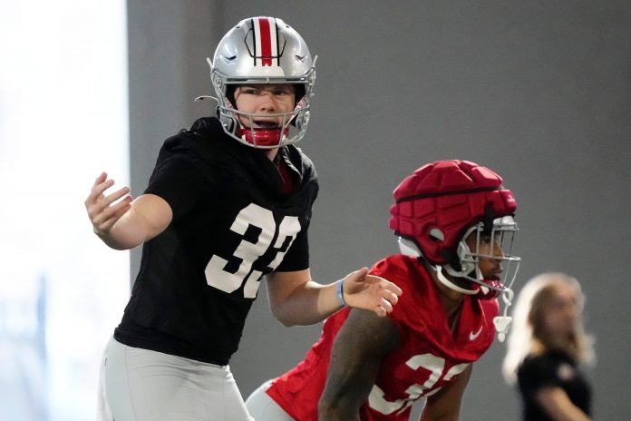 Mar 5, 2024; Columbus, OH, USA; Ohio State Buckeyes quarterback Devin Brown (33) motions during the first spring practice at the Woody Hayes Athletic Center.