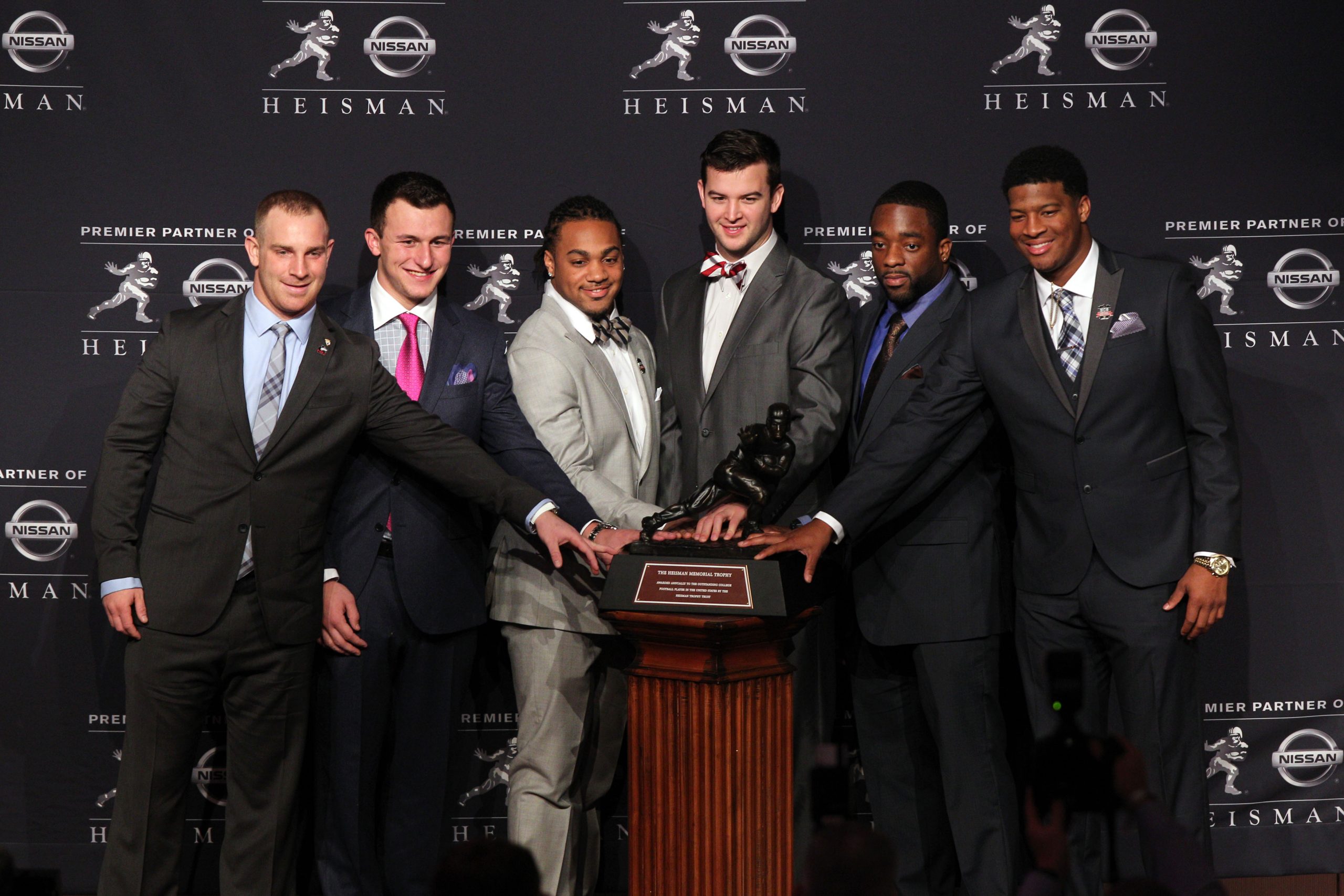 Dec 14, 2013; New York, NY, USA; (From left to right) Nothern Illinois Huskies quarterback Jordan Lynch, and Texas A&M Aggies quarterback Johnny Manziel, and Auburn Tigers running back Tre Mason, and Alabama Crimson Tide quarterback AJ McCarron, and Boston College Eagles running back Andre Williams, and Florida State Seminoles quarterback Jameis Winston pose for a photo during a press conference before the announcement of the 2013 Heisman Trophy winner at the New York Marriott Marquis Times Square in New York. Mandatory Credit: Brad Penner-USA TODAY Sports