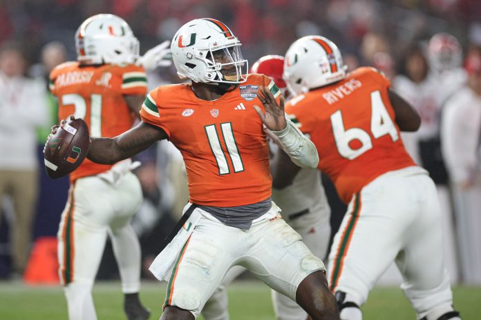 Miami Hurricanes quarterback Jacurri Brown (11) throws the ball during the second half of the 2023 Pinstripe Bowl against the Rutgers Scarlet Knights at Yankee Stadium.
