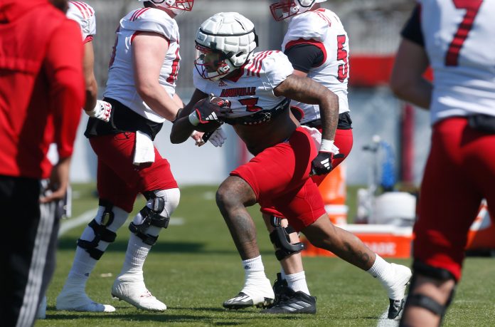 Louisville’s Peny Boone ran the ball during spring practice Friday afternoon.
