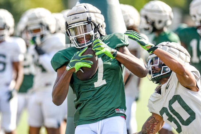 Michigan State receiver Antonio Gates Jr., left, catches a pass as defensive back Justin White closes in during football practice on Wednesday, Aug. 9, 2023, in East Lansing.