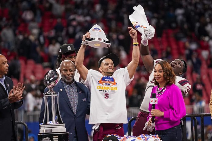 South Carolina State Bulldogs defensive back Decobie Durant (14) receives the Defensive MVP trophy after his team defeated the Jackson State Tigers in the 2021 Celebration Bowl at Mercedes-Benz Stadium.