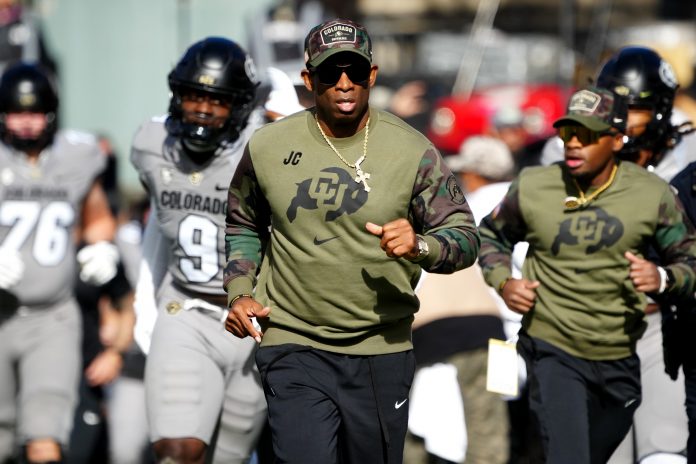 Colorado Buffaloes head coach Deion Sanders runs on to the field before the first half against the Arizona Wildcats at Folsom Field.