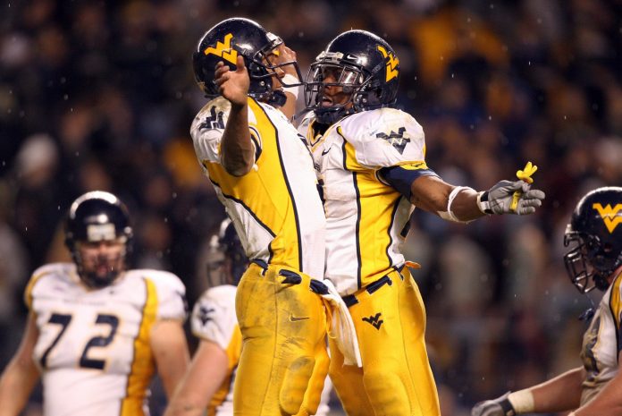 West Virginia Mountaineers running back Steve Slaton (10) (right) bumps chests with West Virginia quarterback Patrick White (5) after scoring a second half touchdown against the Pittsburgh Panthers at Heinz Field in Pittsburgh, PA.