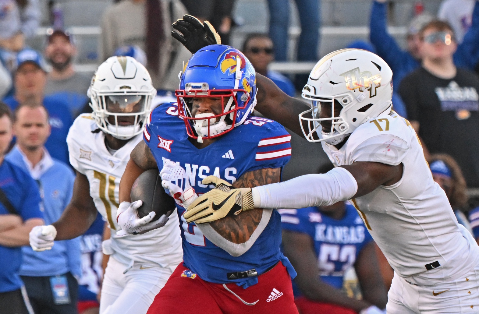 Kansas Jayhawks running back Dylan McDuffie (25) runs up field against UCF Knights linebacker Rian Davis (17) during the second half at David Booth Kansas Memorial Stadium.