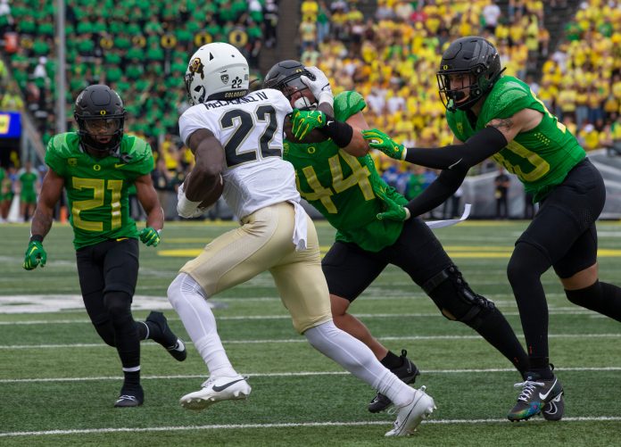 The Oregon defense stops Colorado's Alton McCaskill in the backfield during the fourth quarter in Eugene Saturday, Sept. 23, 2023.