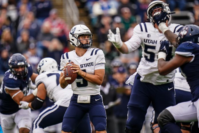 Sep 30, 2023; East Hartford, Connecticut, USA; Utah State quarterback Cooper Legas (5) looks to pass the ball against the UConn Huskies in the second half at Rentschler Field at Pratt & Whitney Stadium. Mandatory Credit: David Butler II-USA TODAY Sports