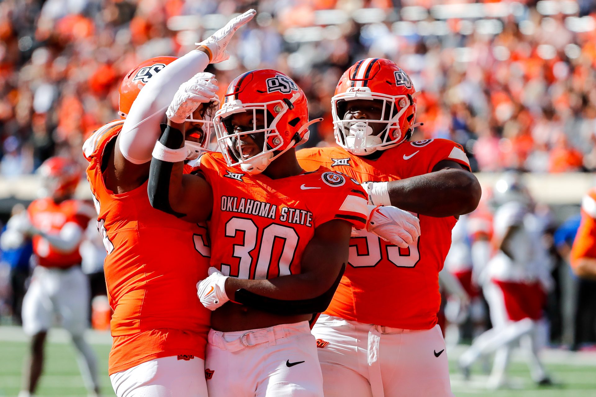 Oct 14, 2023; Stillwater, Oklahoma, USA; Oklahoma State's Collin Oliver (30) celebrates after a sack against the Kansas Jayhawks in the second quarter at Boone Pickens Stadium. Mandatory Credit: Nathan J. Fish-USA TODAY Sports