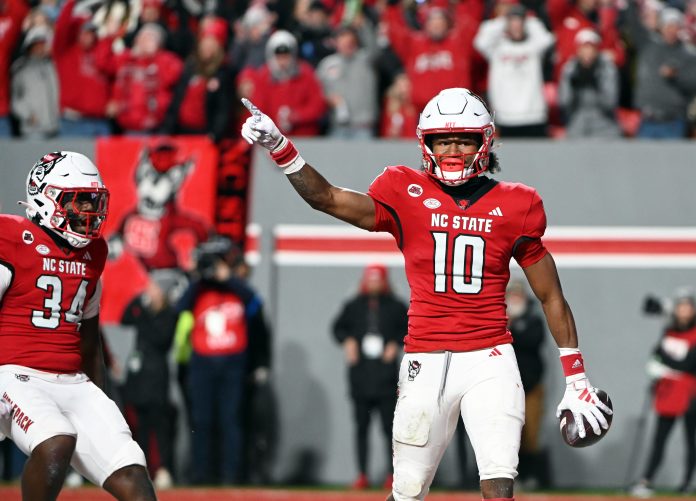 Nov 25, 2023; Raleigh, North Carolina, USA; North Carolina State Wolfpack receiver KC Concepcion (10) reacts after scoring a touchdown against the North Carolina Tar Heels during the first half at Carter-Finley Stadium. Mandatory Credit: Rob Kinnan-USA TODAY Sports