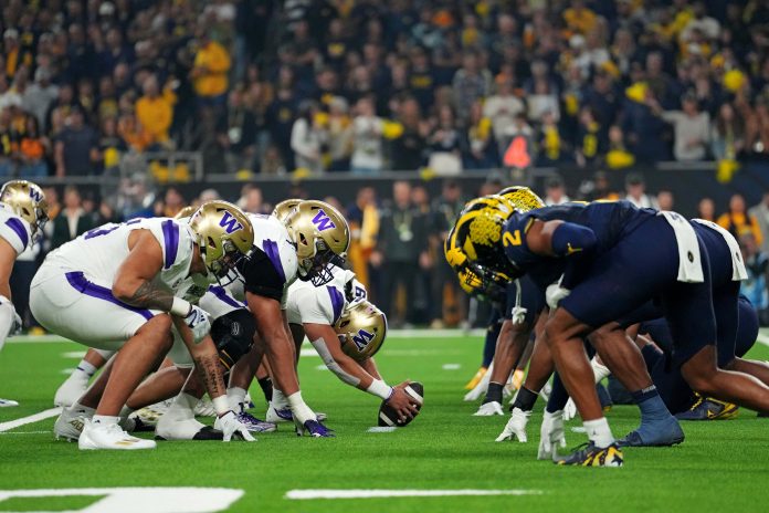 Jan 8, 2024; Houston, TX, USA; The Washington Huskies and the Michigan Wolverines line up at the line of scrimmage during the first quarter in the 2024 College Football Playoff national championship game at NRG Stadium. Mandatory Credit: Kirby Lee-USA TODAY Sports