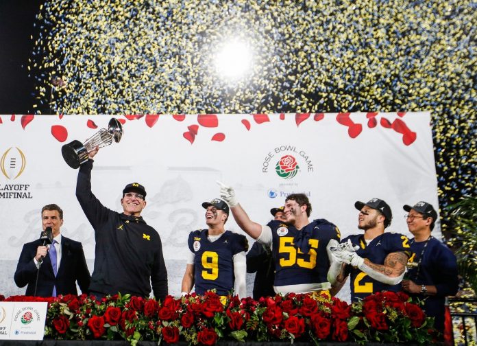 Jan. 1, 2024: Michigan head coach Jim Harbaugh lifts up the Rose Bowl trophy after a 27-20 win over Alabama in the College Football Playoff semifinal at the Rose Bowl in Pasadena, California.