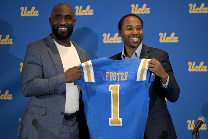 Feb 13, 2024; Los Angeles, CA, USA; UCLA Bruins athletic director Martin Jarmond, right, with new head football coach DeShaun Foster during a press conference at Pauley Pavilion. Mandatory Credit: Jayne Kamin-Oncea-USA TODAY Sports