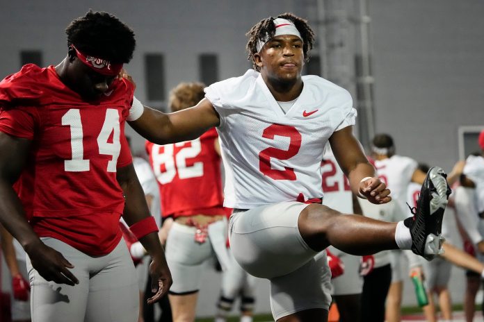 Mar 5, 2024; Columbus, OH, USA; Ohio State Buckeyes safety Caleb Downs (2) stretches with wide receiver Kojo Antwi (14) during the first spring practice at the Woody Hayes Athletic Center.