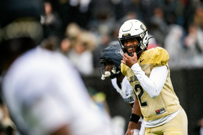 Colorado's Shedeur Sanders smiles before taking a snap during a Colorado football spring game at Folsom Field in Boulder, Colo., on Saturday, April 27, 2024.