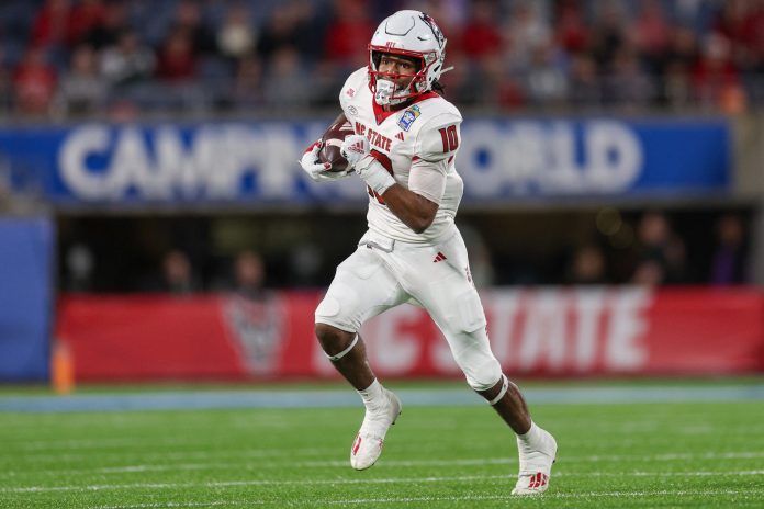 North Carolina State Wolfpack wide receiver Kevin Concepcion (10) runs with the ball against the Kansas State Wildcats in the second quarter during the Pop-Tarts bowl at Camping World Stadium.