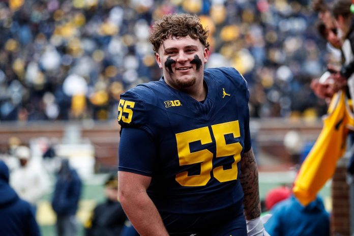 Blue Team defensive lineman Mason Graham (55) walks up the tunnel for halftime during the spring game at Michigan Stadium.