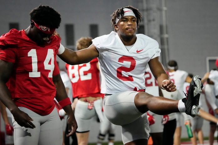 Ohio State Buckeyes safety Caleb Downs (2) stretches with wide receiver Kojo Antwi (14) during the first spring practice at the Woody Hayes Athletic Center.